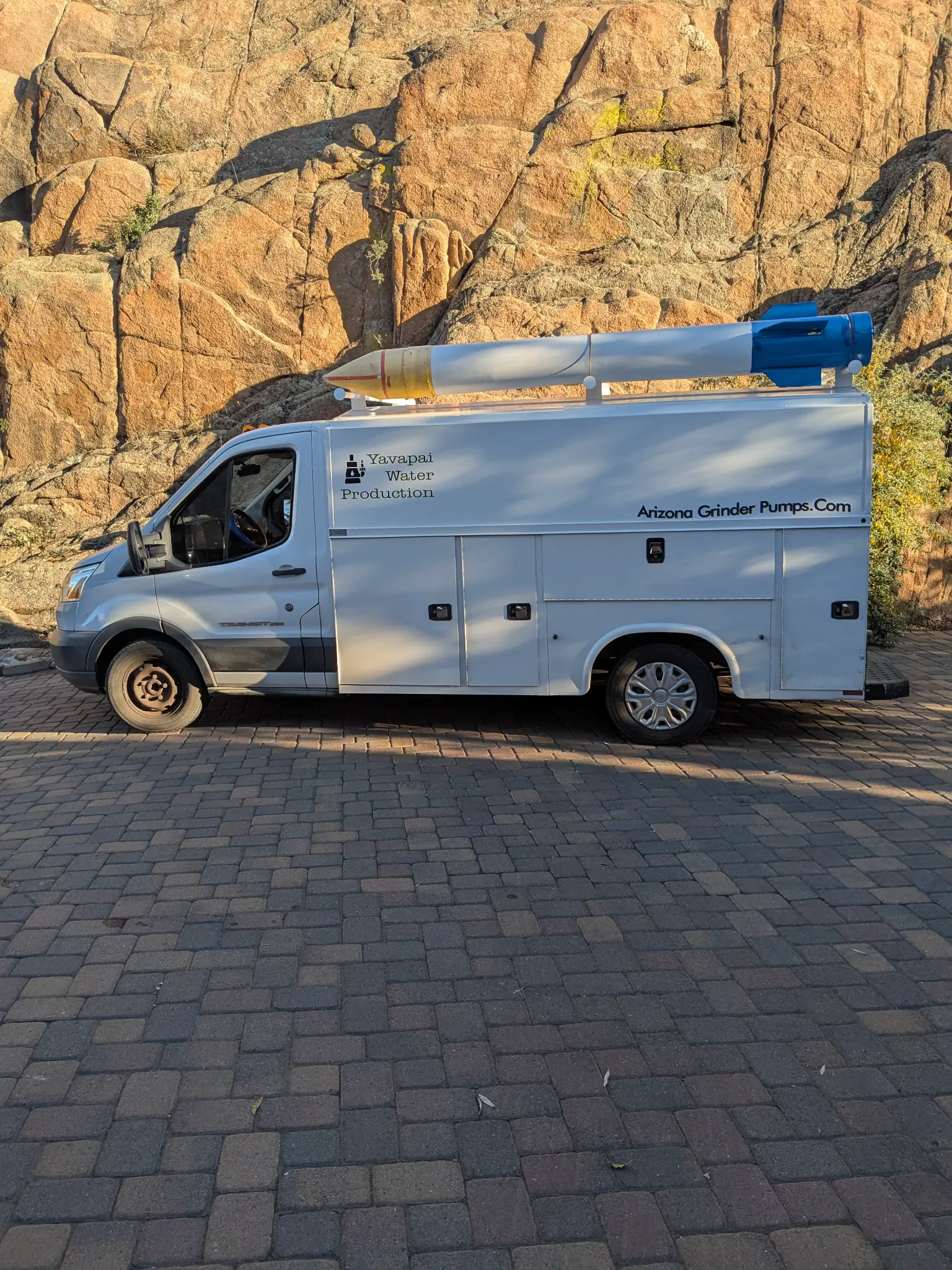 Authentic client photo of the rocket-topped service van in Prescott